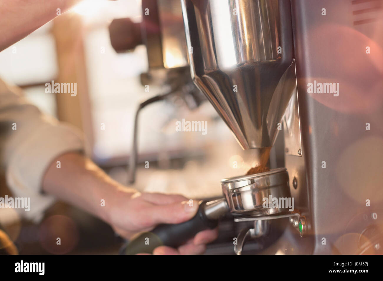 Close up barista using espresso machine grinder in cafe Stock Photo Alamy