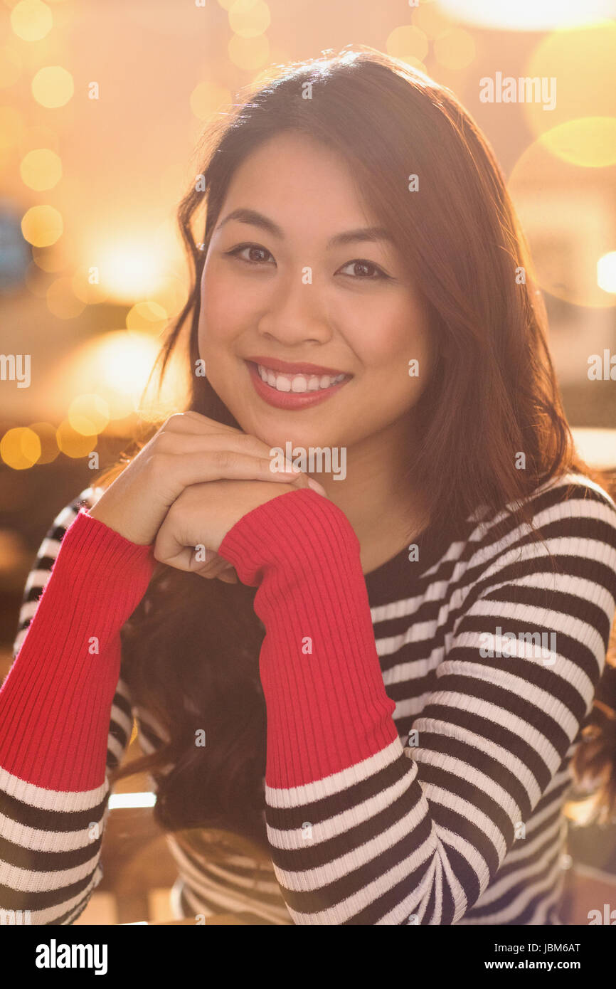 Portrait smiling Chinese woman wearing striped sweater Stock Photo