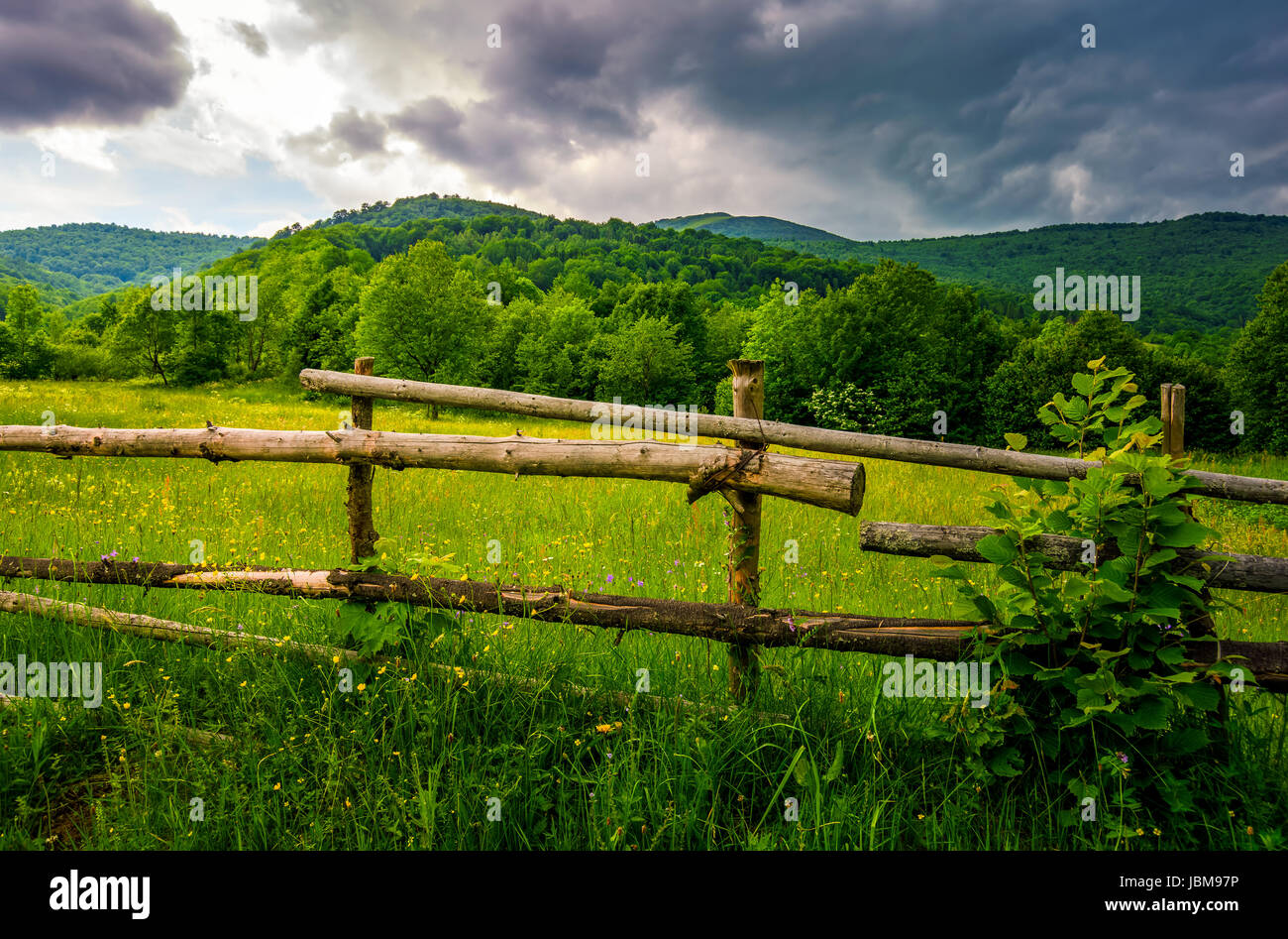 wooden fence on hillside in the rural area. classic countryside ...