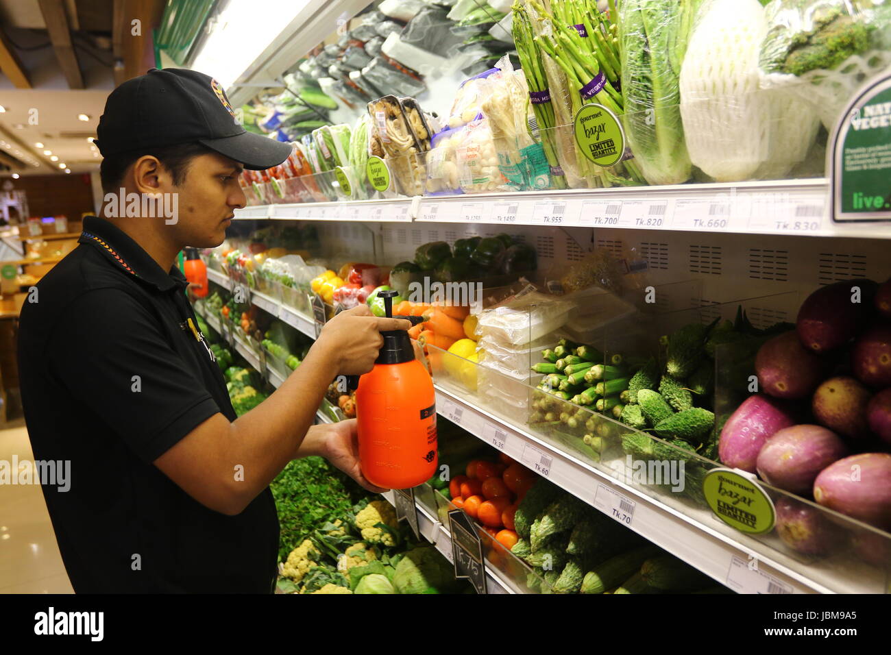 Shop worker Spray Water Fruits and vegetable Stock Photo Alamy