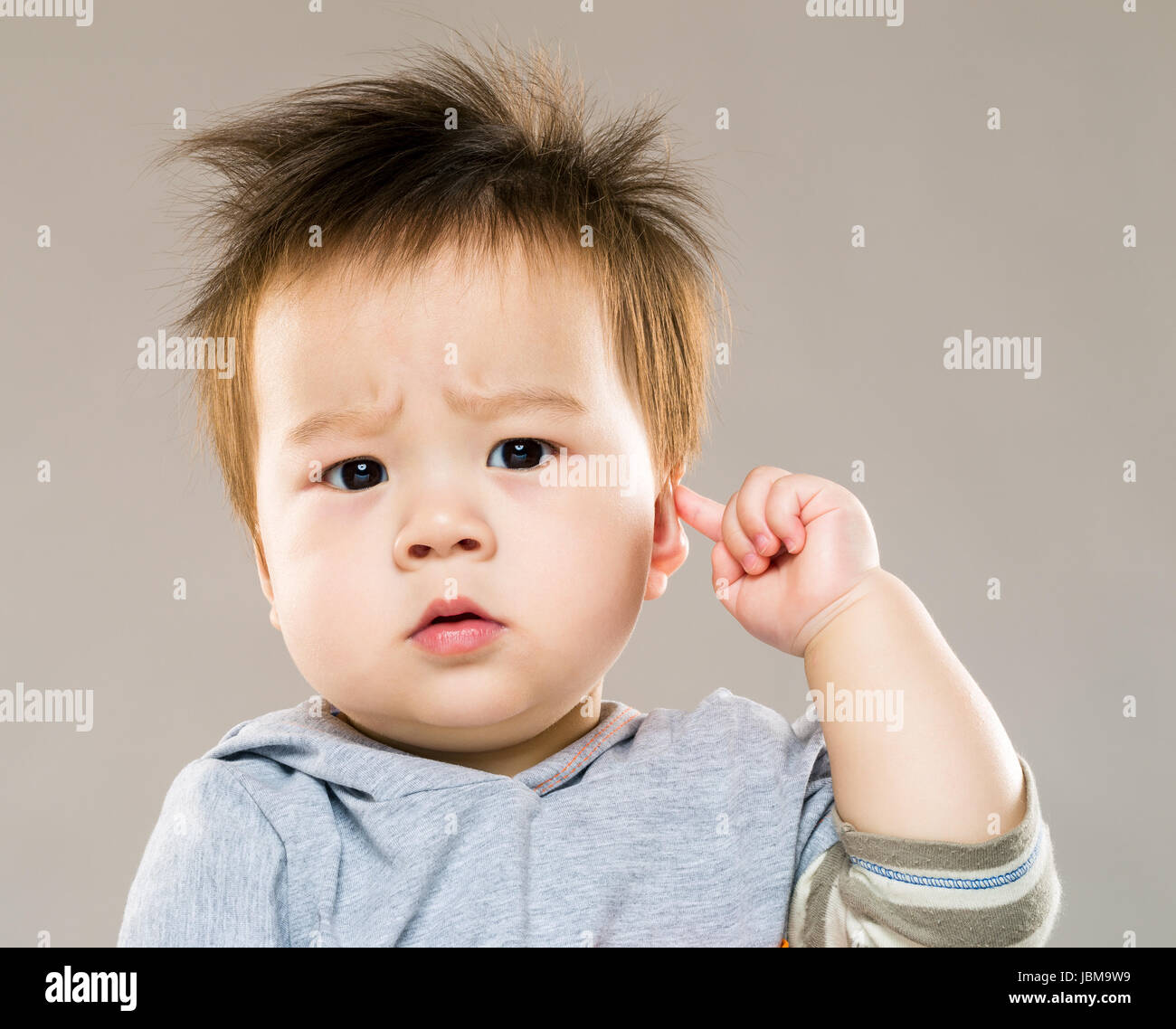 Baby boy touch his ear Stock Photo Alamy