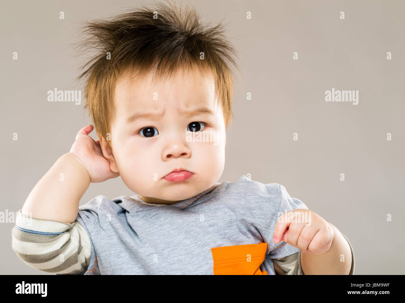 Baby scratching head Stock Photo Alamy