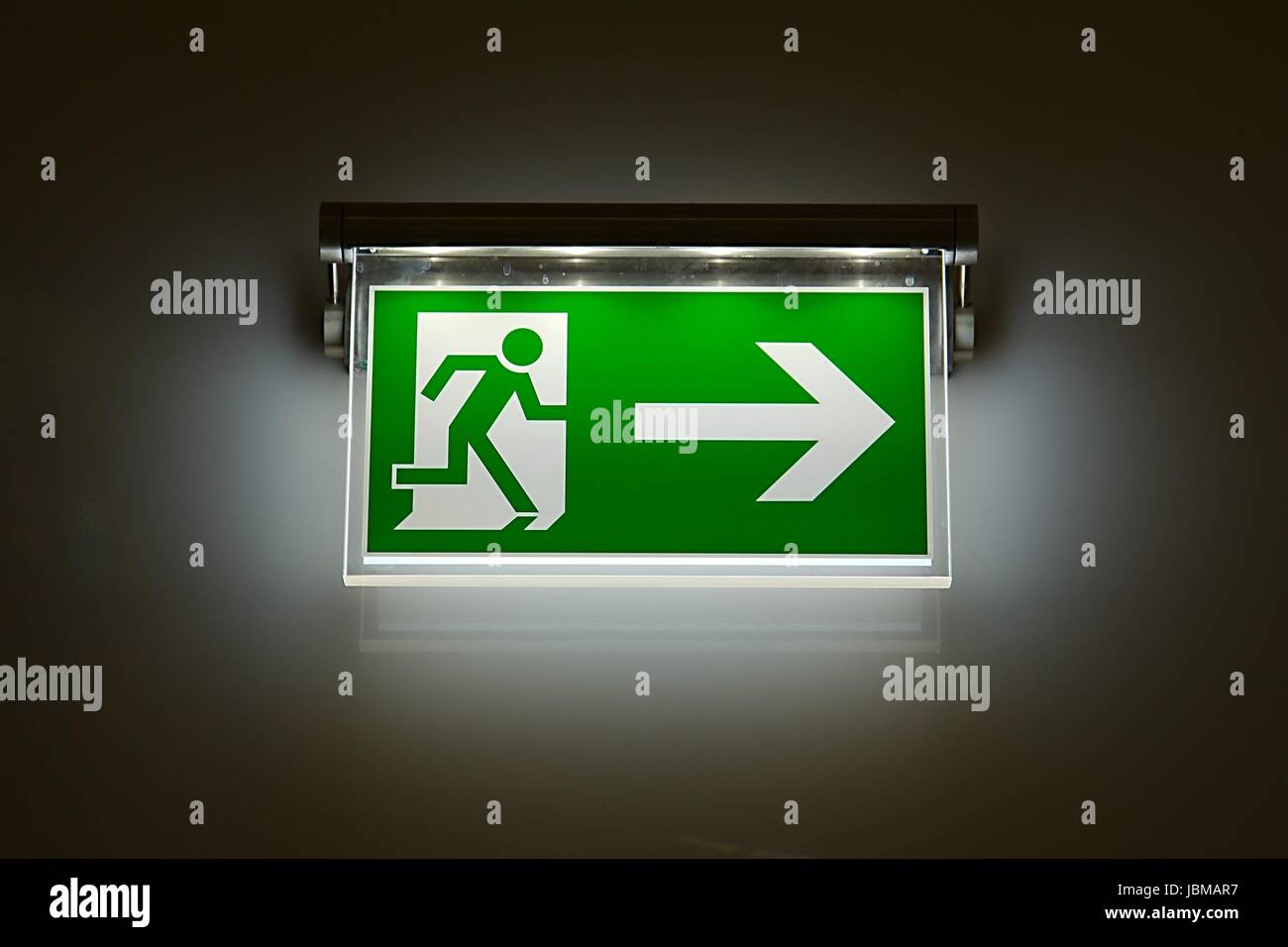 Emergency exit sign glowing in the dark Stock Photo Alamy