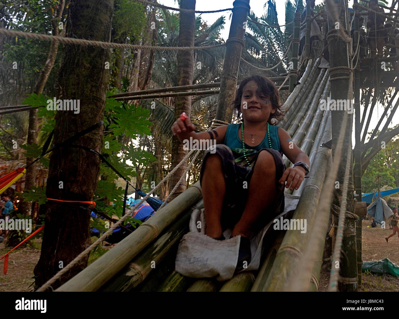 A child heads down the bamboo slide in the Envision village at the 2015 Envision Festival, a transformational festival on Costa Rica's Pacific Coast. Stock Photo