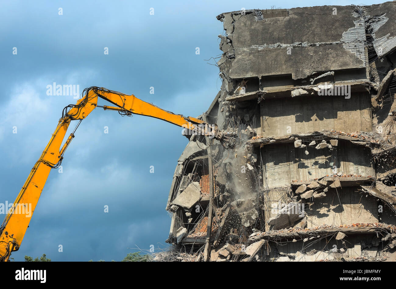 Heavy equipment being used to tear tearing down building construction Stock Photo