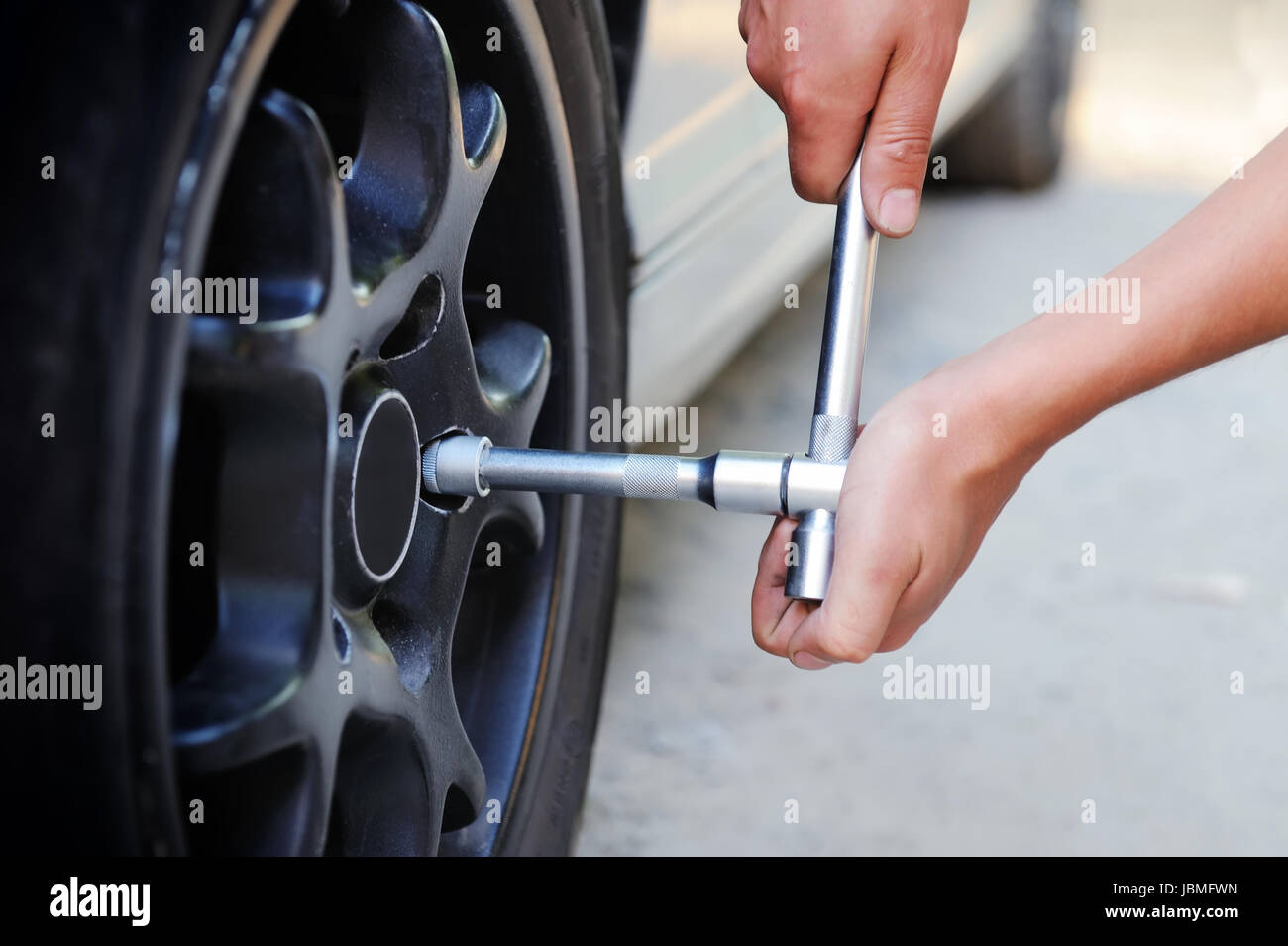 Auto mechanic changing car wheel Stock Photo Alamy