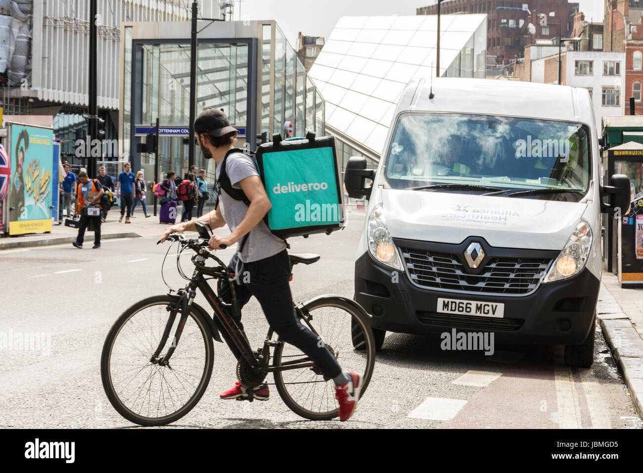 A Deliveroo rider on his bike in central London, UK Stock Photo