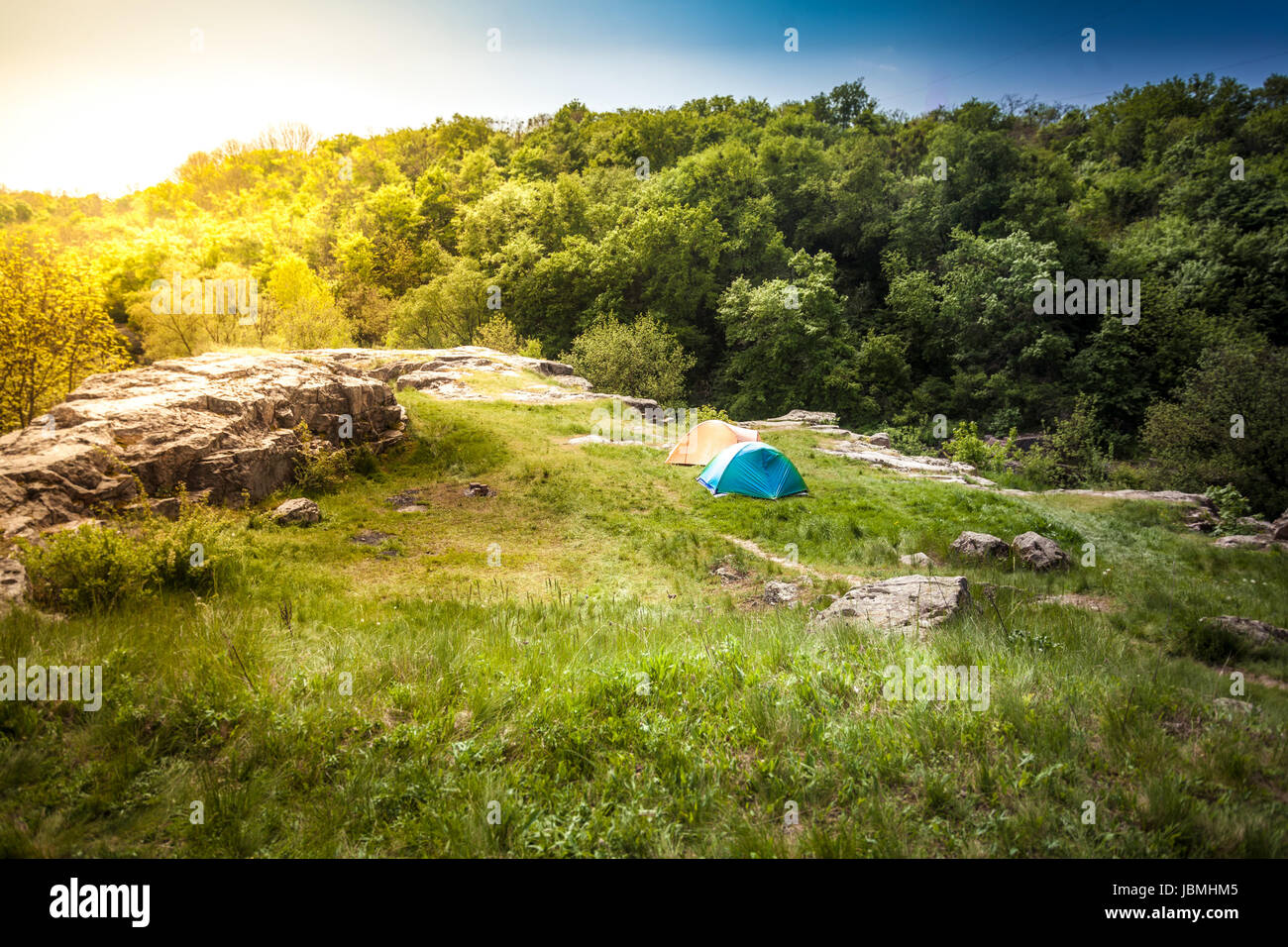 Beautiful landscape of tents on top of mountain at sunset Stock Photo ...