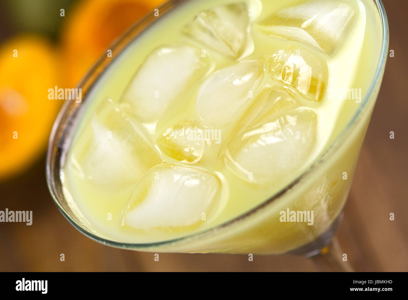 Peruvian cream liqueur made of lucuma fruit served in cocktail glass with ice cubes (Selective Focus, Focus one third into the ice cubes) Stock Photo