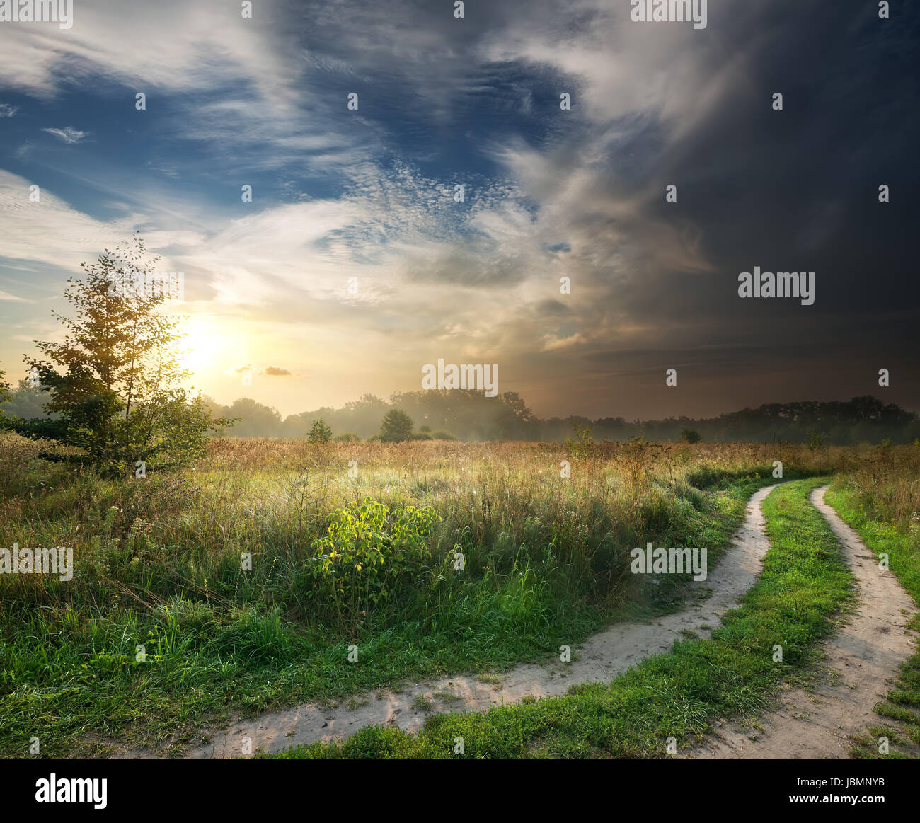 Storm clouds and fog over the country road Stock Photo - Alamy