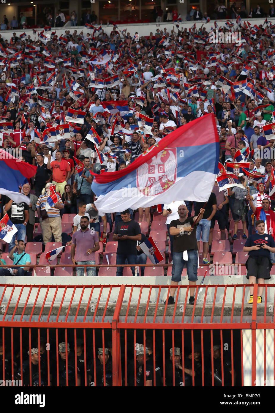 Police on duty underneath Serbia fans in the stands during the 2018 FIFA World Cup Qualifying, Group D match at the Rajko Mitic Stadium, Belgrade. Stock Photo