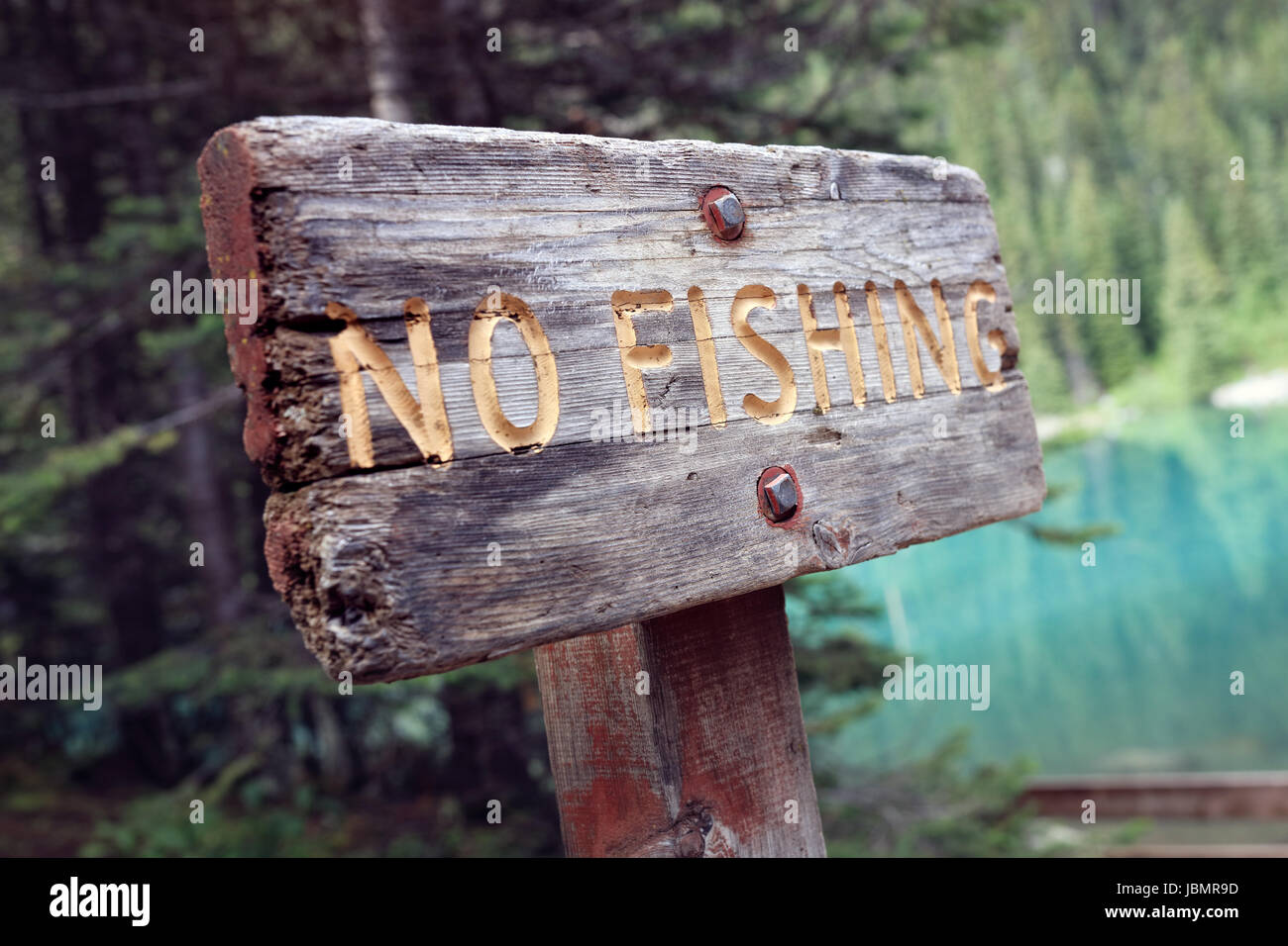 No fishing prohibited warning sign by lake Stock Photo