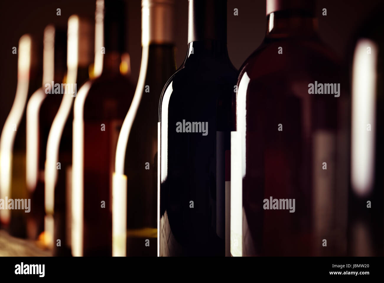 Bottles of old aged wine collection in a row in winery cellar Stock Photo