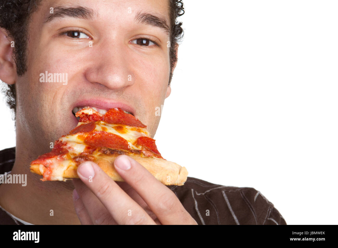 Young man eating pepperoni pizza Stock Photo Alamy