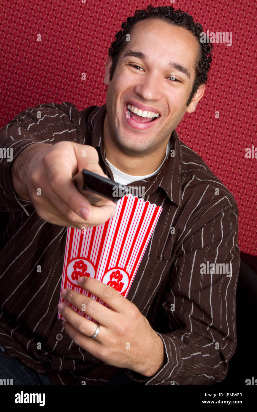 Young popcorn man watching tv Stock Photo Alamy