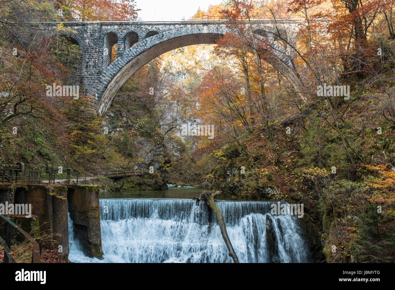 A rail bridge in the Viintgar Gorge, Slovenia with a waterfall Stock Photo