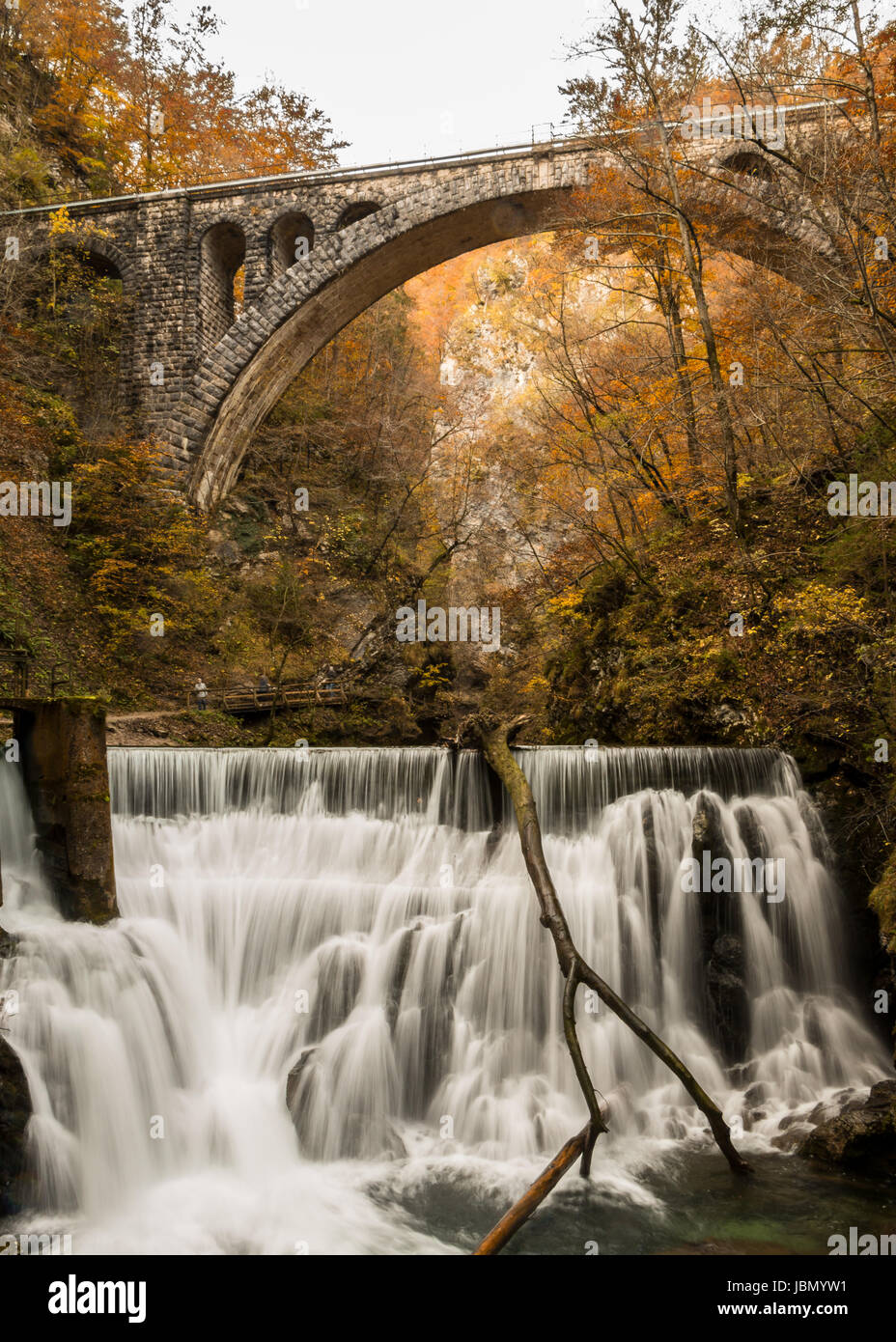 A rail bridge in the Viintgar Gorge, Slovenia with a waterfall Stock Photo
