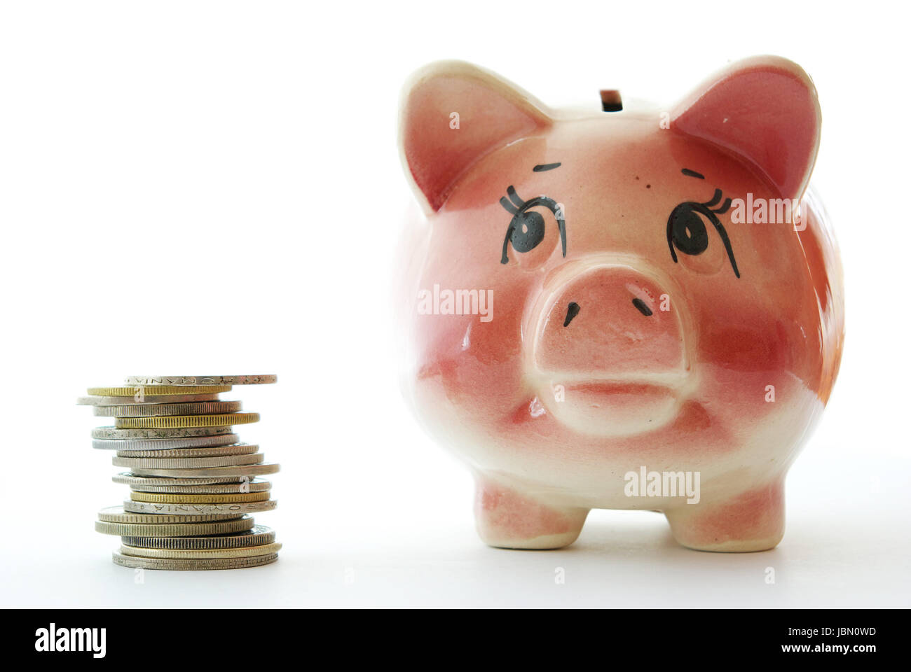 Pink piggy bank isolated on white background with coins Stock Photo - Alamy