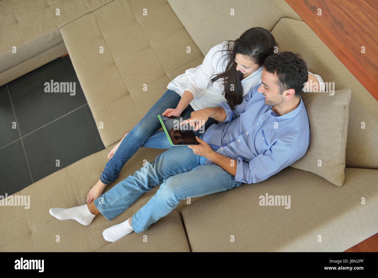 happy young couple at modern home using tablet computer Stock Photo - Alamy