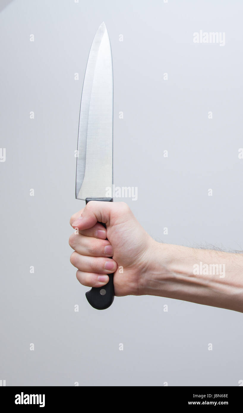 closeup of man hand holding big knife Stock Photo