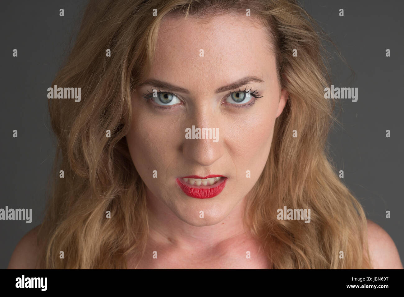 Close Up Image Of Caucasian Woman With Sandy Blond Hair Showing