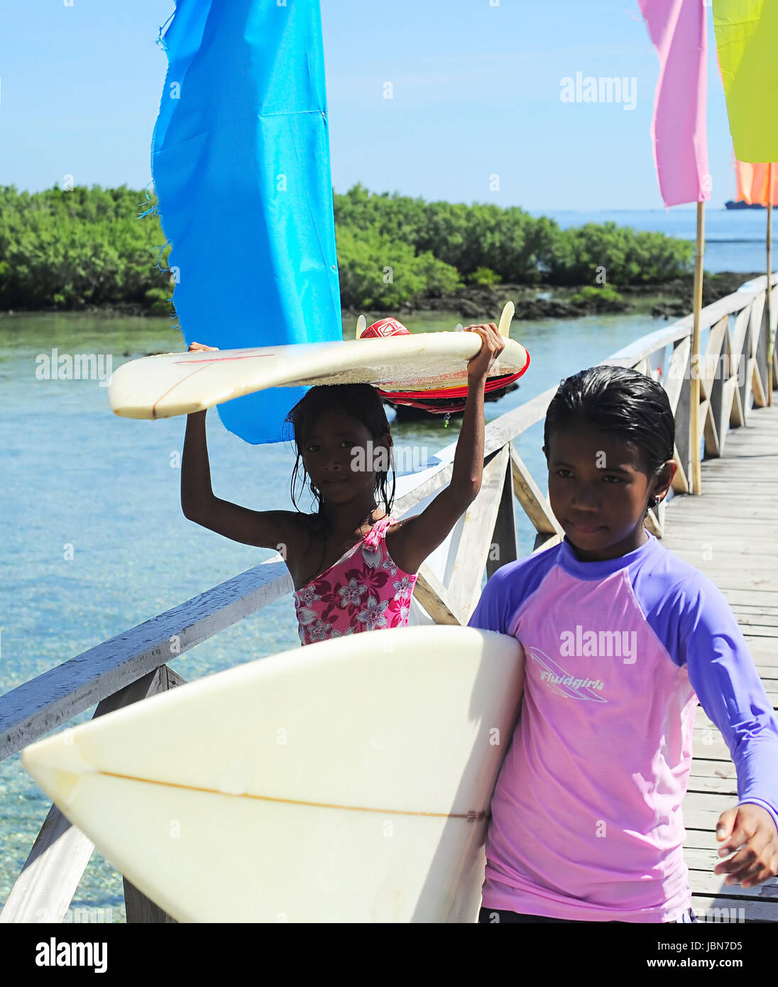 SIARGAO, PHILIPPINES MAY 07, 2012 Two young surfers carrying