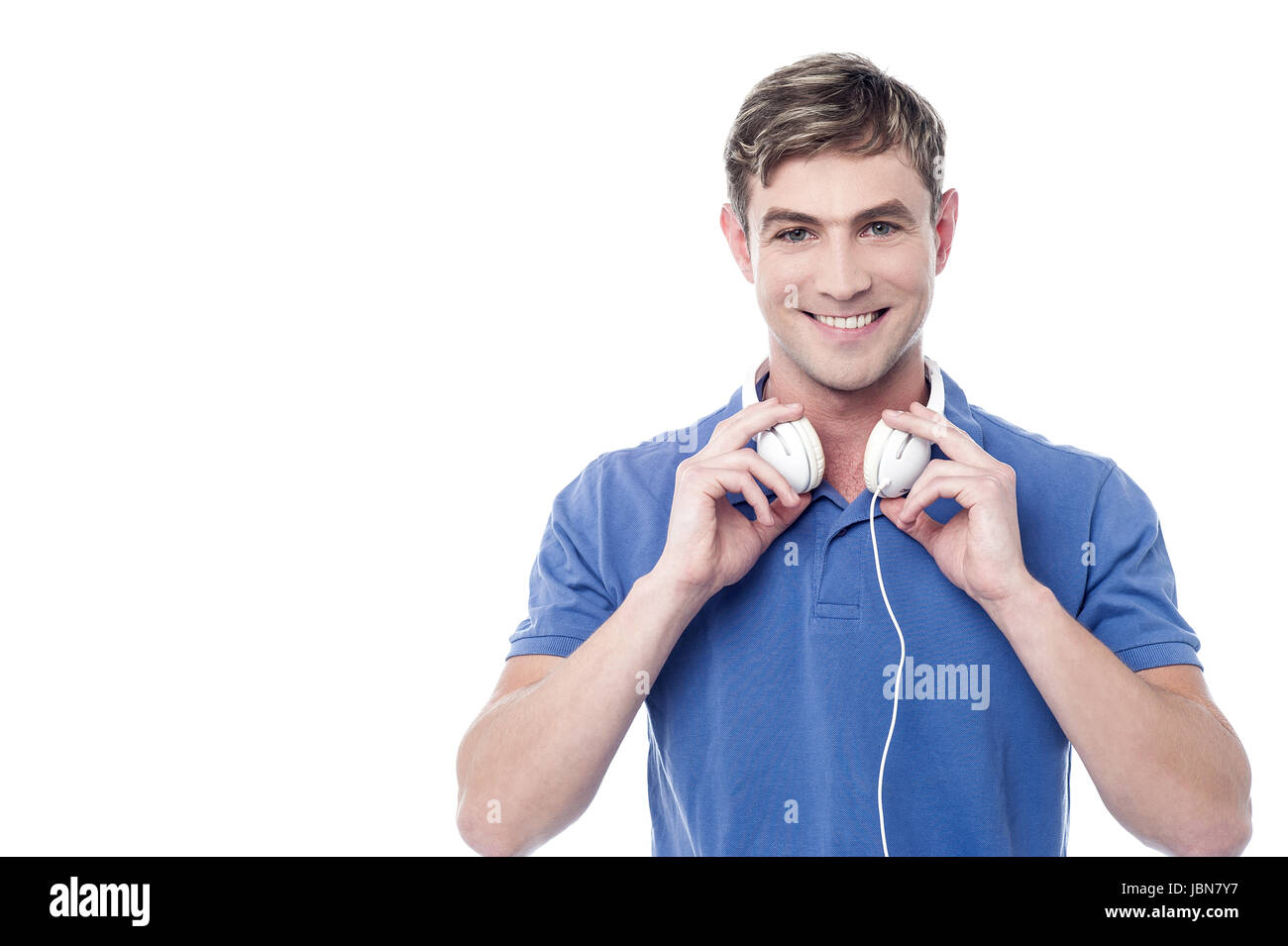 Smiling stylish man with headphone around his neck Stock Photo Alamy