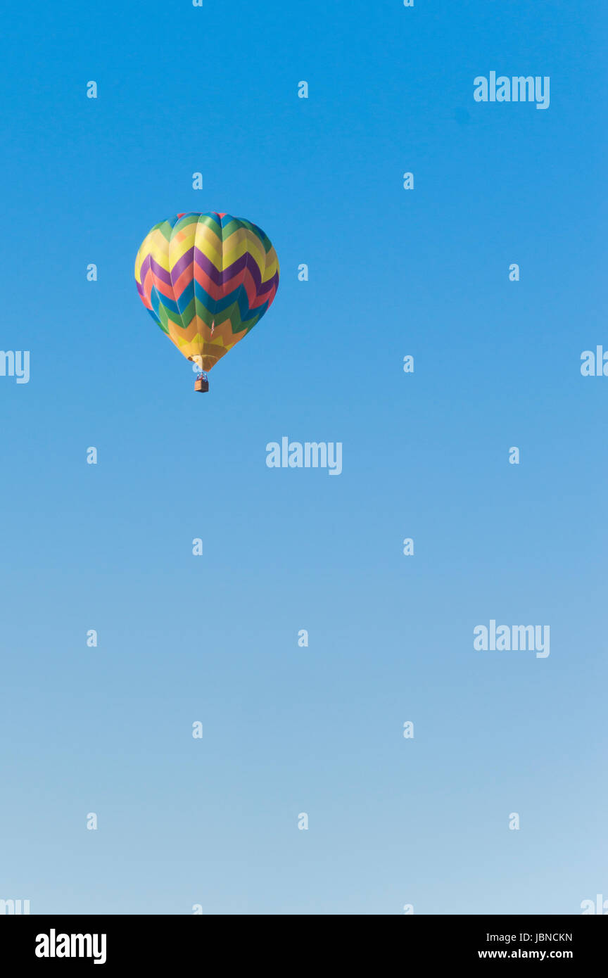 Isolated Hot Air Balloon in a blue sky Stock Photo - Alamy