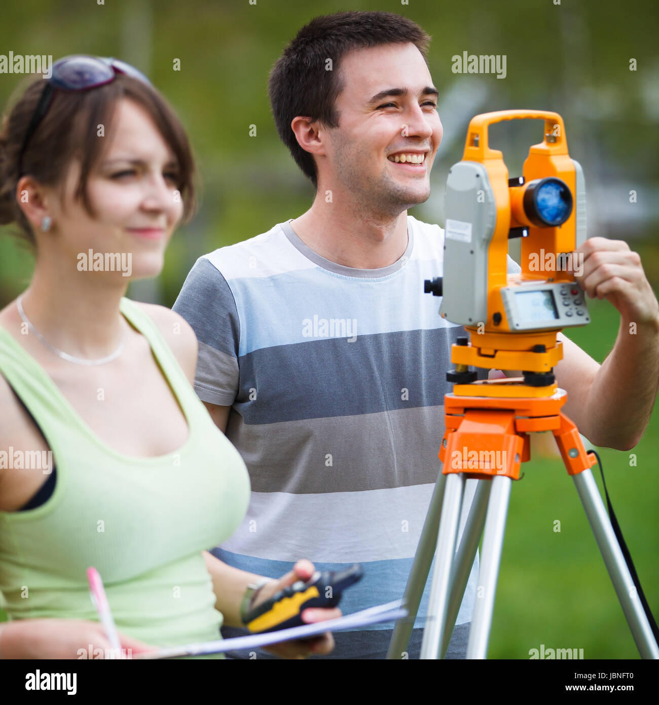 Two young land surveyors at work Stock Photo