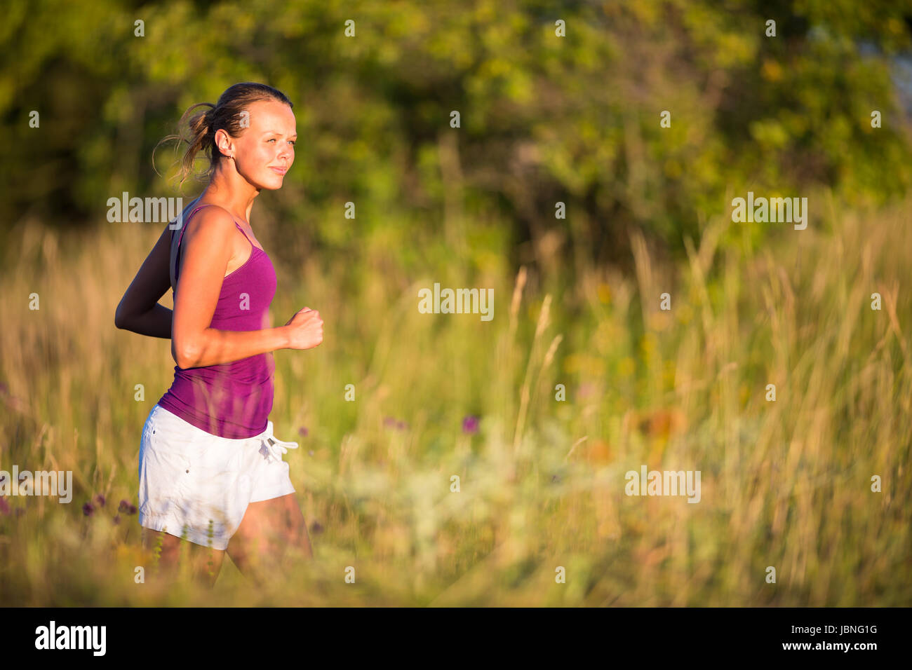 Young woman running outdoors on a lovely sunny day Stock Photo - Alamy