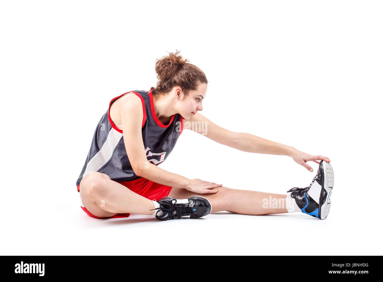 Wnba Stretchig Basketball woman stretching leg on white background Stock Photo - Alamy