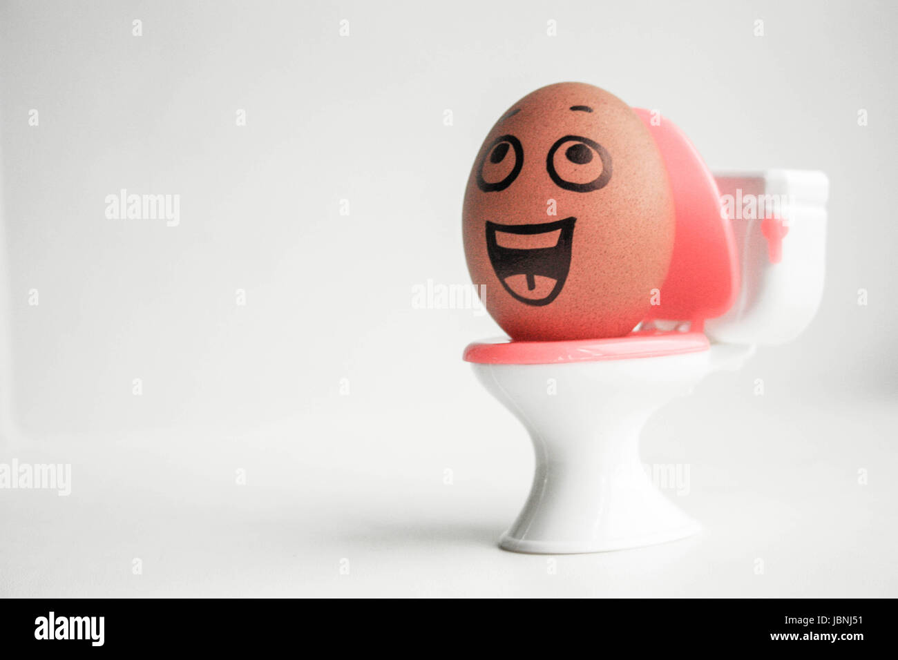 Constipation and diarrhea. Egg on the toilet. An egg with a face. Photo