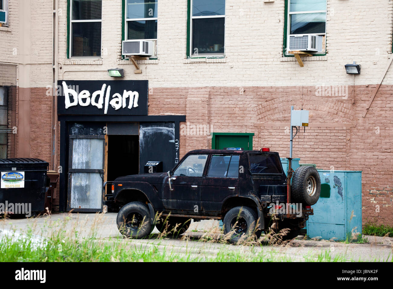 Door open to the radical theater called Bedlam with black utility vehicle parked outside. Minneapolis Minnesota MN USA Stock Photo
