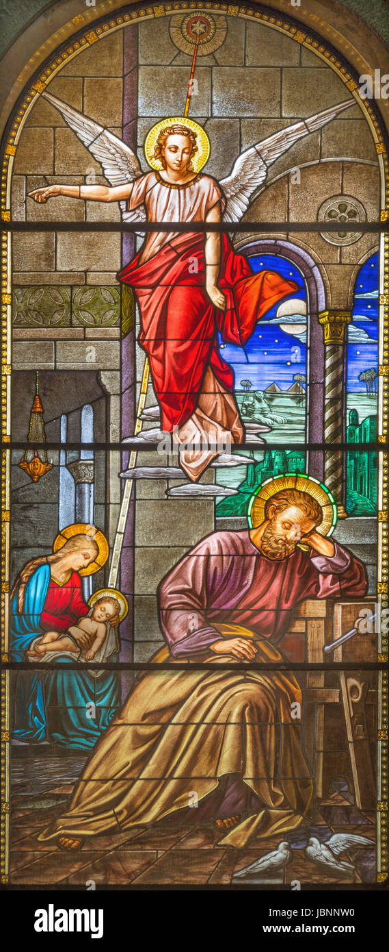 TURIN, ITALY - MARCH 15, 2017: The vision of angel to St. Joseph in the dream on the stained glass of church Basilica Maria Ausiliatrice Stock Photo