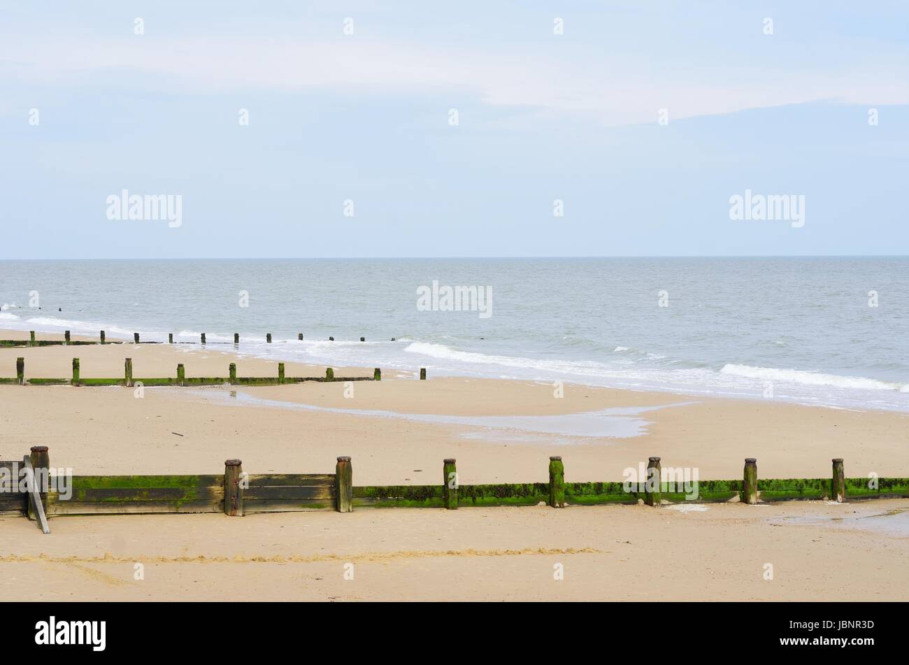 Sandy beach with breakwaters Stock Photo