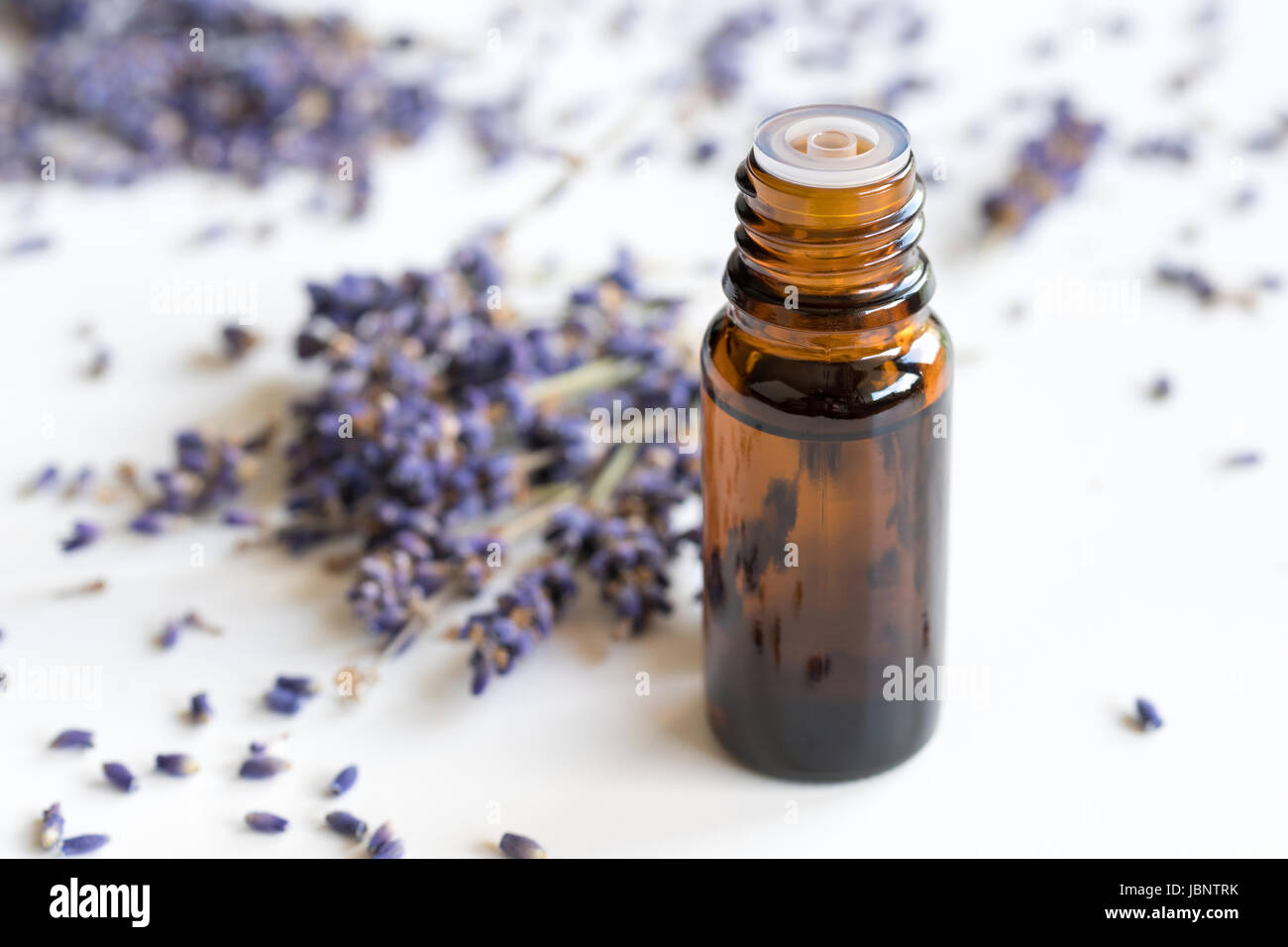 A bottle of lavender essential oil on a white background Stock Photo ...