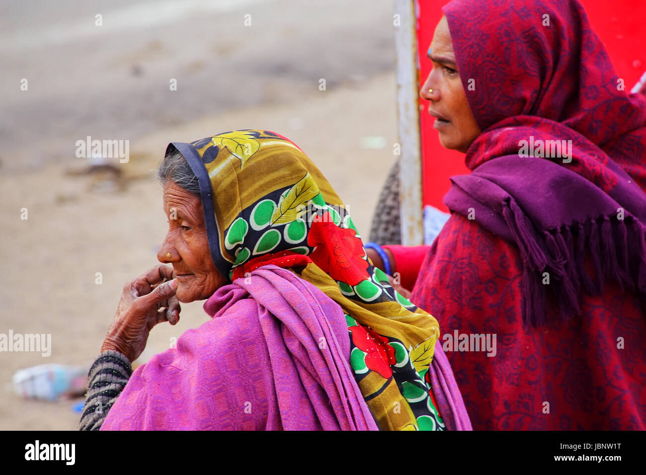 Local women sitting near Amber Fort in Rajasthan, India. Amber Fort is the main tourist attraction in the Jaipur area. Stock Photo