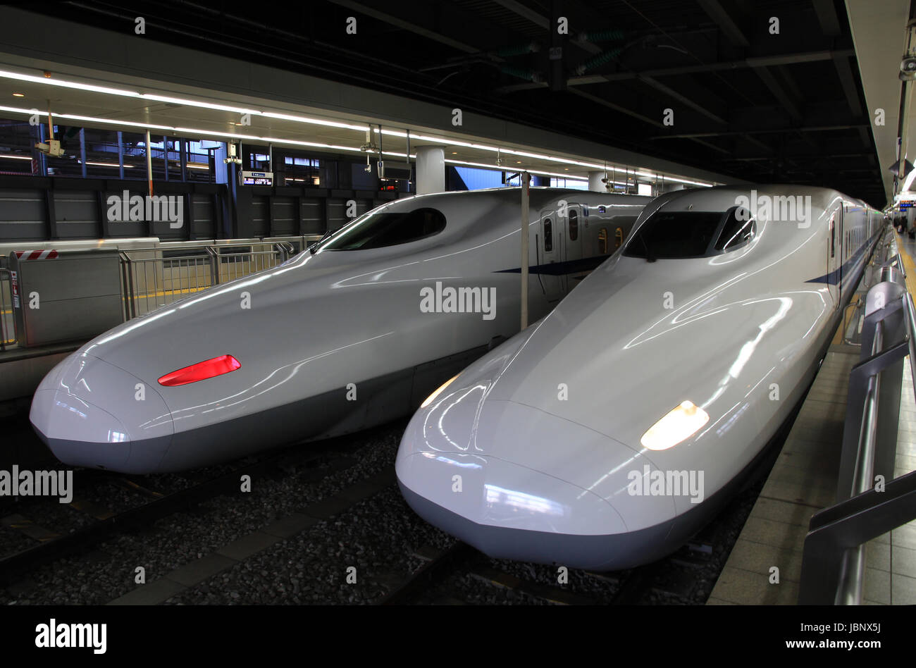 The front and rear of Shinkansen bullet trains are shown side by side at Tokyo Station, Tokyo, Japan Stock Photo