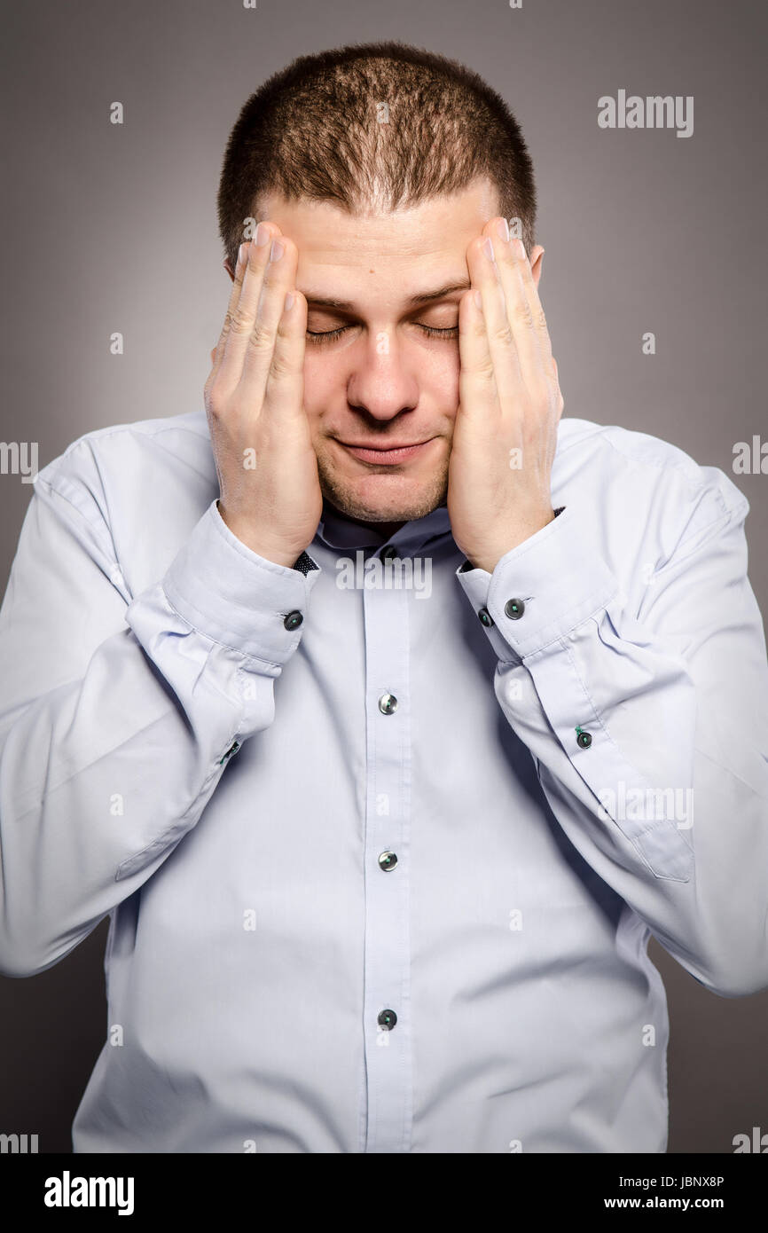 a man is suffering from very strong headaches Stock Photo