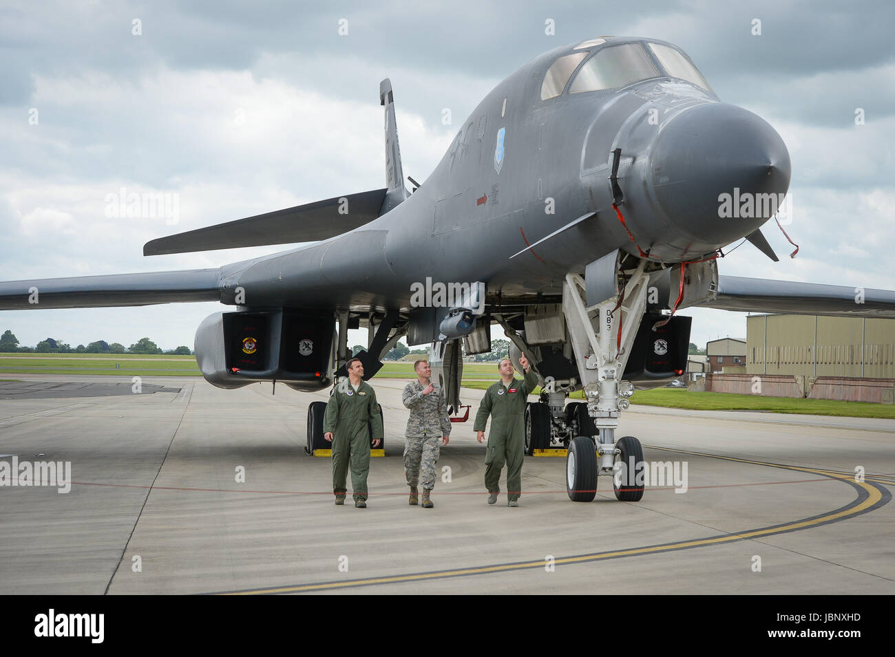 The flight crew of a B-1B Lancer check over the bomber as it sits on the pan at RAF Fairford. Stock Photo
