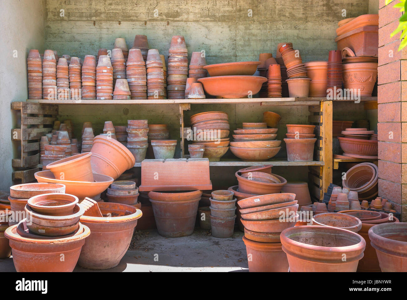 Plant pots stored on shelves in the Botanical Garden in Cagliari, Sardinia. Stock Photo