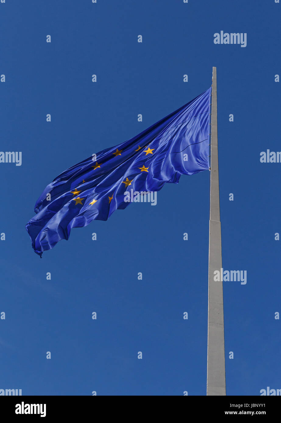 European Union flag on flagpole against blue sky Stock Photo - Alamy