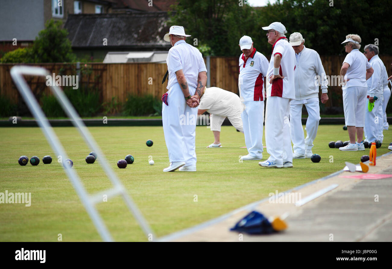 People playing lawn bowls outdoors on a bowling green in Hampshire, UK Stock Photo