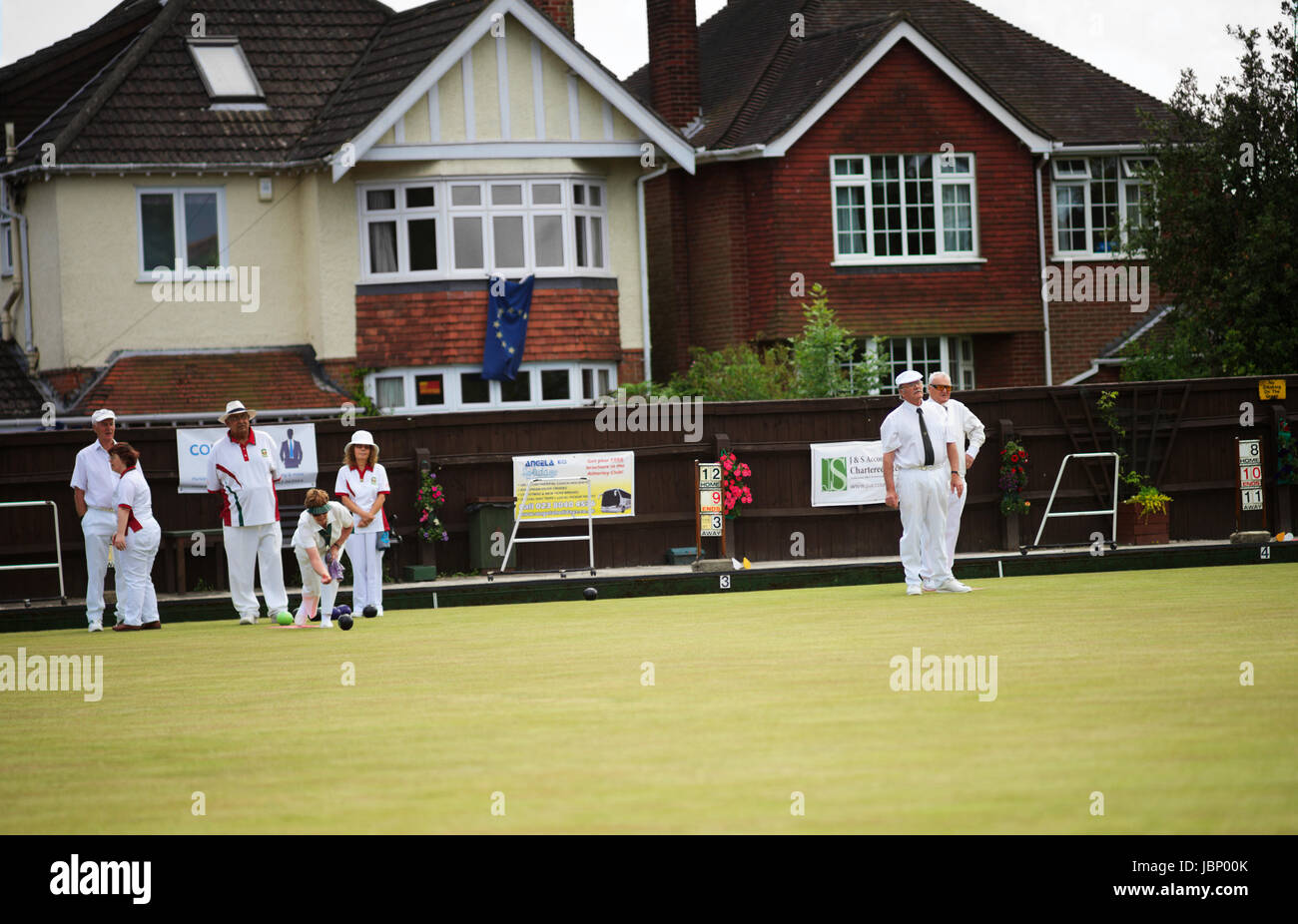 People playing lawn bowls outdoors on a bowling green in Hampshire, UK Stock Photo