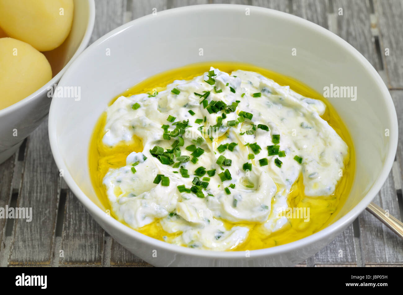 curd cheese with boiled potatoes linseed oil and chive, close up, macro, full frame Stock Photo