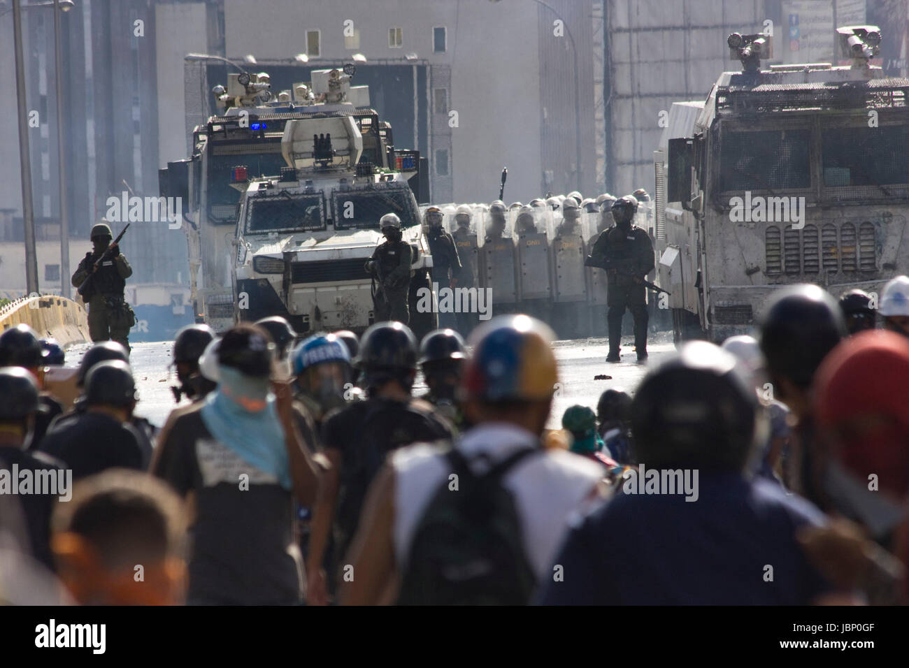 Demonstrators clash with the Bolivarian National Guard during a protest against government of Nicolas Maduro in Caracas. Stock Photo