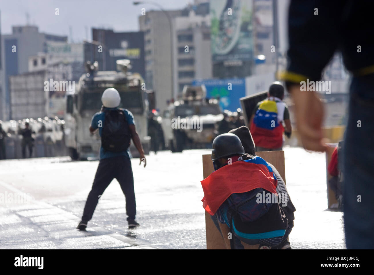 Demonstrators clash with the Bolivarian National Guard during a protest against government of Nicolas Maduro in Caracas. Stock Photo