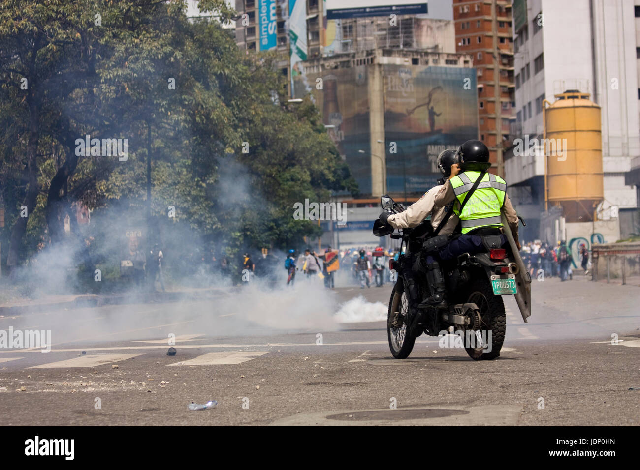 Police officers clash with demonstrators during a protest against the government of Nicolas Maduro in Caracas. Stock Photo