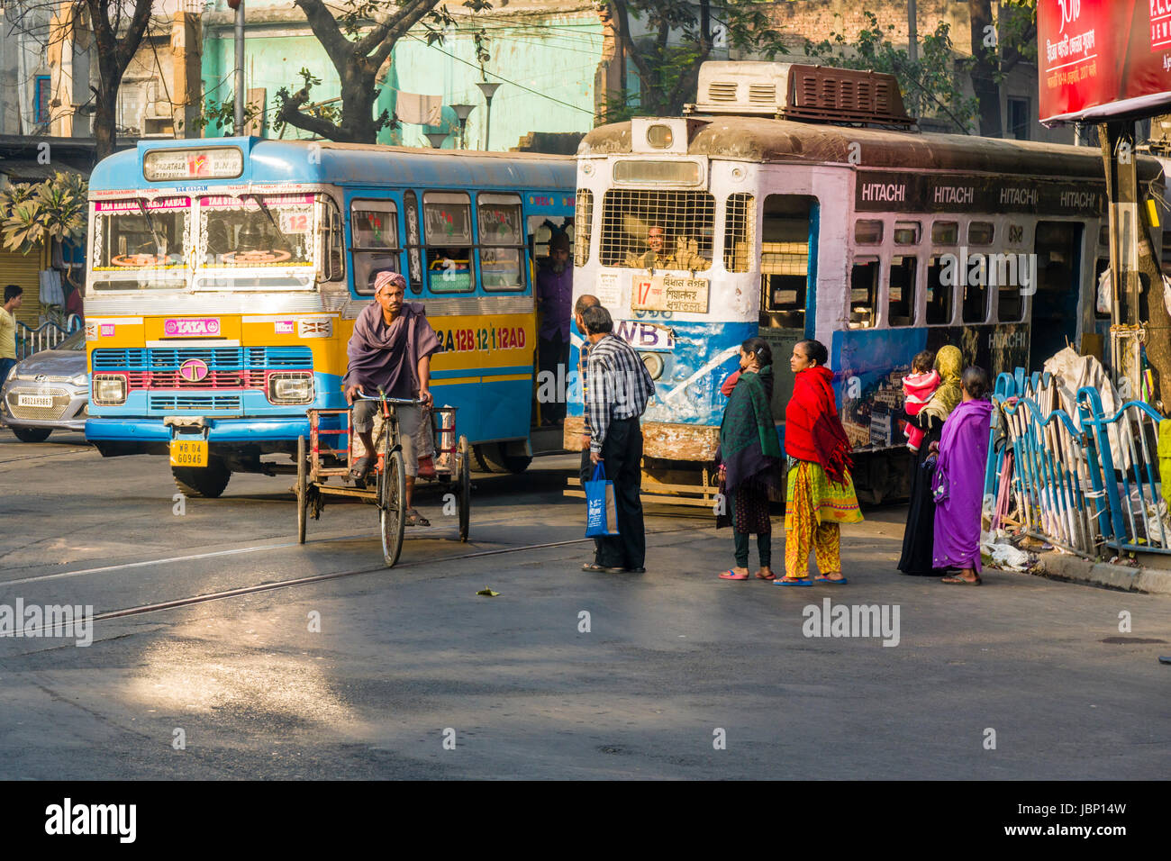 A bus, a cyclist and a tram on a busy road in the suburb Sealdah Stock Photo