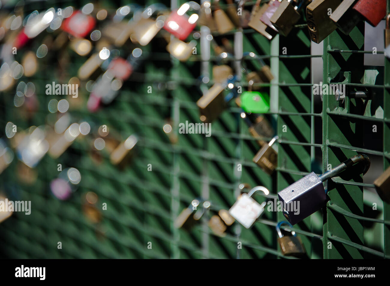 Close-up of a large number of padlocks attached to metal bridge railing across river l'Arve in Chamonix Stock Photo